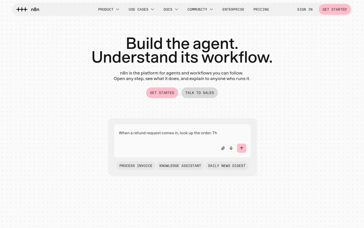n8n website, showing the home page headline about building agents above a workflow prompt box