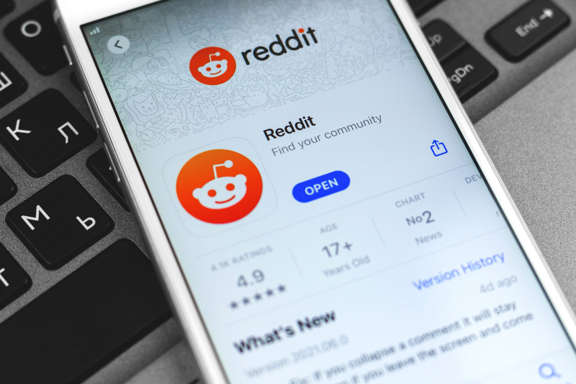 reddit application in a phone above the keyboard