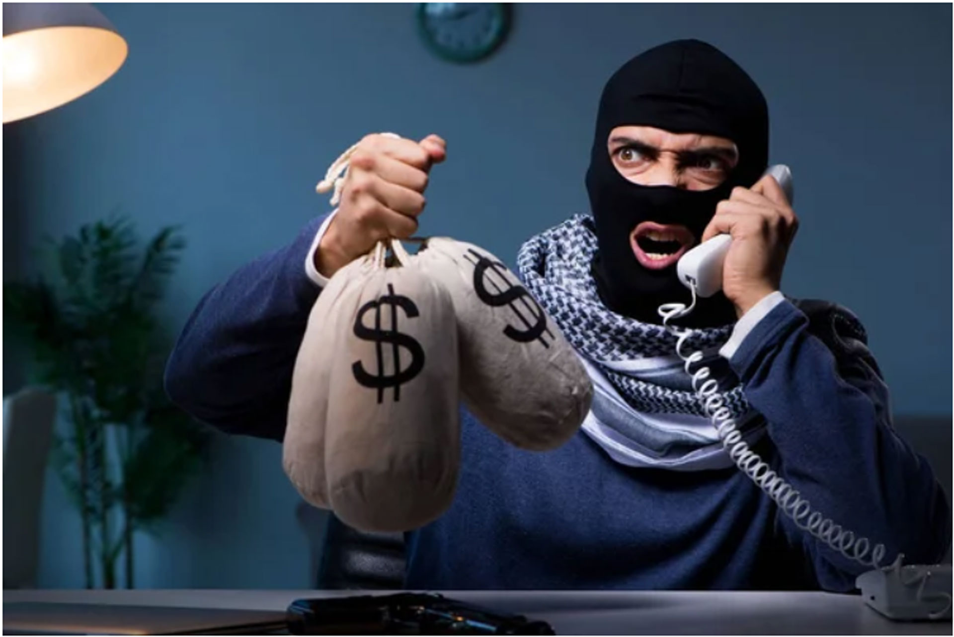 terrorist holding bags of money asking ransom money through a phone call