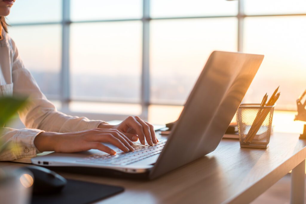 Adult businesswoman working at home using computer, studying business ideas on a pc screen on-line